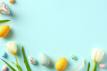 Happy Easter background with tulips and colorful eggs. Flat lay, top view.