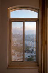 Window with Ramallah Cityscape at Dawn with High Buildings and Trees
