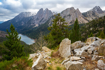Naklejka na ściany i meble Picturesque rocky landscape of Aiguestortes National Park overlooking twin peaks of Encantats and Sant Maurici lake in autumn day, Lleida, Spain