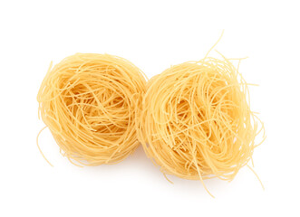 Raw pasta nests on white background