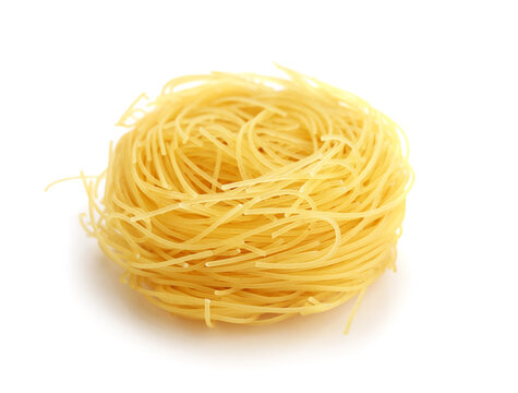 Raw pasta nest on white background