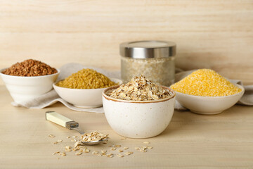 Bowls with different cereals on wooden table