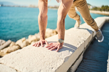 young guy exercising with calisthenics workout in an outdoor gym