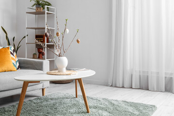 Stylish interior of light living room with Easter decor