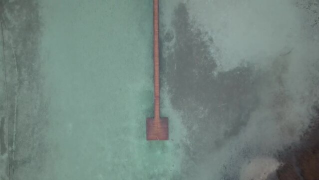 Aerial Drone View. FOG Wooden pier with clear lake in the Alps in summer, Wooden pier at Lake Fuschlsee in summer.