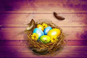 Easter background with colorful easter eggs on wooden background.