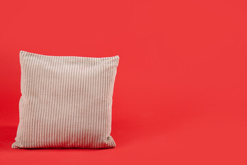 Soft pillow on red background