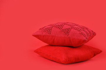 Soft decorative pillows on red background