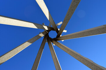 blue sky against upward structure of concrete teepee