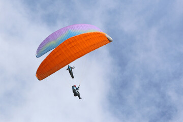 	
Paragliders flying in a cloudy sky