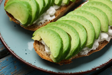 Delicious avocado toast and cream cheese on plate, closeup