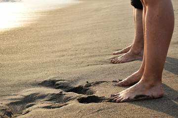 two feet of two people on the seashore