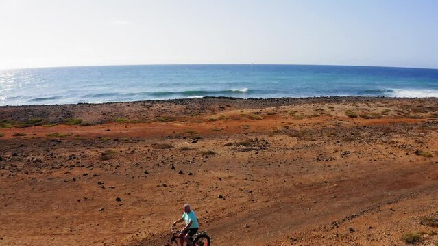 Drone flight over bikers family, Sal Island coast, Cape Verde, Atlantic Ocean, Africa.