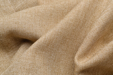 Fototapeta premium Closeup view of crumpled beige fabric as background
