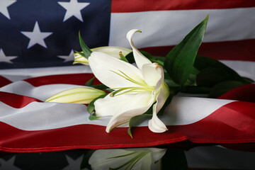 USA flag with lilies on table. National Day of Prayer and Remembrance for the Victims of the...