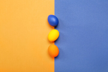 Painted Easter eggs on blue and orange background