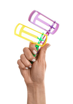 Woman with Jewish rattles for Purim holiday on white background