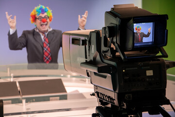 An emotional man in a clown costume in a television studio