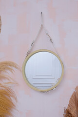 Round mirror frame complete with synthetic leather strap