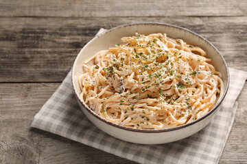 Delicious pasta with mushroom sauce on wooden table