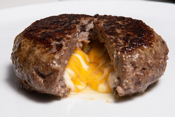 Fried cutlet with egg inside served on a plate.