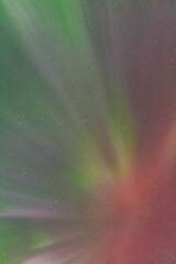 Beautiful bright curtains of Aurora Borealis Northern Lights seen in Yukon Territory with green, purple and pink tones. 