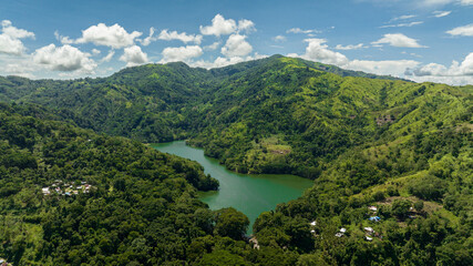 A beautiful lake among the mountains with tropical vegetation. Lake Balanan. Negros, Philippines