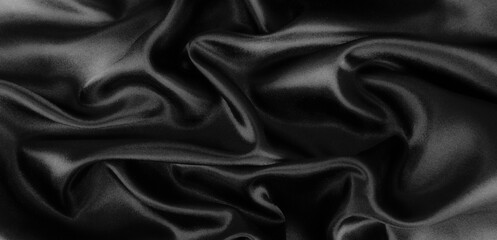 Smooth elegant black silk or satin luxury cloth texture background.