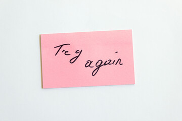 Try again inscription on pink paper