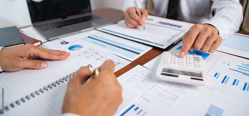 Poster asian businessmen discuss graphs and chart data analysis and use calculators to calculate numbers. b