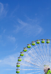 section of a ferris wheel against a blue sky