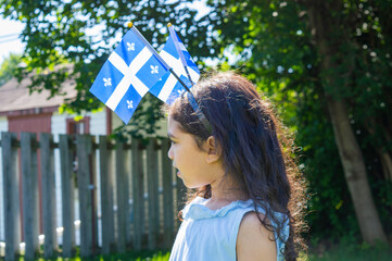 Fototapeta premium Girl celebrates the national holiday, Drapeau québec - Happy Quebec Day Quebec's National Holiday, La Fete Nationale du Quebec, St. Jean-Baptiste