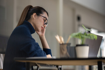 Asian women sitting in an office With stress and eye strain Tired, portrait of sad unhappy tired...