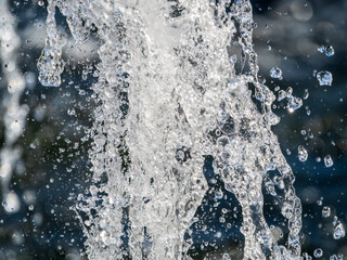Splashes and jets of water against light background.