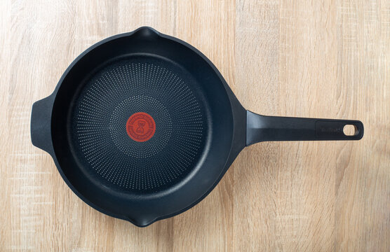 Zaporozhye, Ukraine - February 26, 2023: TEFAL ROBUSTO frying pan on the kitchen table. top view