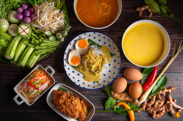 Rice noodles with fish curry sauce and spicy curry sauce, southern style with vegetables set, fried chicken, boiled egg and pickled vegetables, Thai traditional style. (Kanom Jeen Nam Ya)