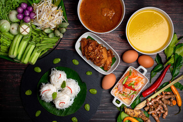 Rice noodles with fish curry sauce and spicy curry sauce, southern style with vegetables set, fried chicken, boiled egg and pickled vegetables, Thai traditional style. (Kanom Jeen Nam Ya)