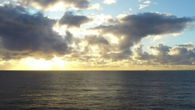 Aerial drone shot flying towards a beautfiul sunrise over the ocean near Bondi Austraia