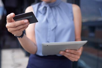 Businesswoman, hands and tablet with credit card for ecommerce, online shopping or banking outdoors. Hand of female holding touchscreen with 5G connection for internet purchase or app transaction