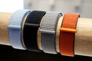 colorful wrist watch straps. Nylon strap  for electronic watches, on a wooden stand.      