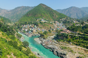 Devprayag, Godly Confluence,Garhwal,Uttarakhand, India. Here Alaknanda meets the Bhagirathi river and both rivers thereafter flow on as the Holy Ganges river or Ganga. Sacred place for Hindu devotees. - obrazy, fototapety, plakaty