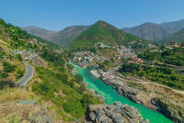 Devprayag, Godly Confluence,Garhwal,Uttarakhand, India. Here Alaknanda meets the Bhagirathi river and both rivers thereafter flow on as the Holy Ganges river or Ganga. Himalayan mountains background.