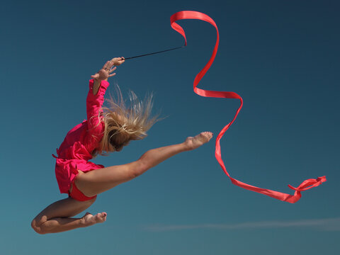 woman rhythmic gymnast with red ribbon