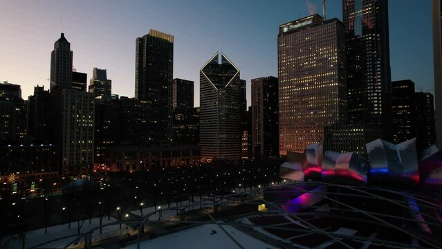 Slowly revealing chicago beauty. Establishing aerial from lakefront chicago, above millenium park in the night. Illinois, USA, winter 4k