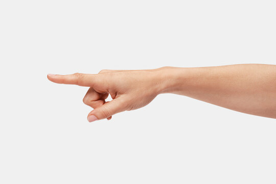Woman's hand pointing to the left with the index finger.
