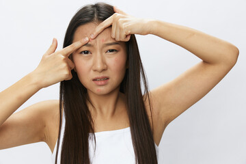 Asian woman facial skin problems, acne and inflammation, red rashes and allergies, chicken pox,...
