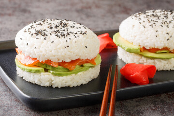 Delicious and exquisite sushi burger with vegetables and salmon fish as Japanese appetizers close-up. Horizontal