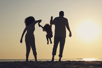 Fototapeta premium Silhouette, beach and a family with children by the ocean, playing together in nature at sunset from the back. Summer, travel or love with a mother, father and kid having fun while bonding at the sea