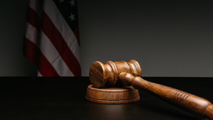 Gavel on court desk on background of USA flag
