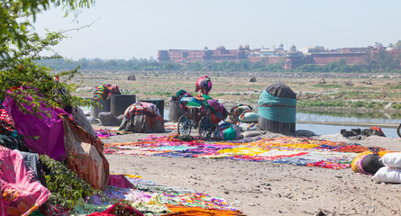 Indian people washing cloth on the sandy banks of Yamuna river in Agra